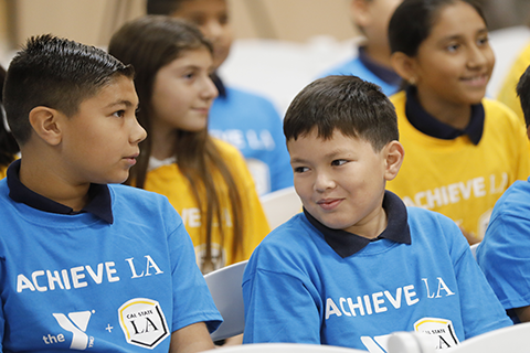 Young students wearing Achieve LA t-shirts.