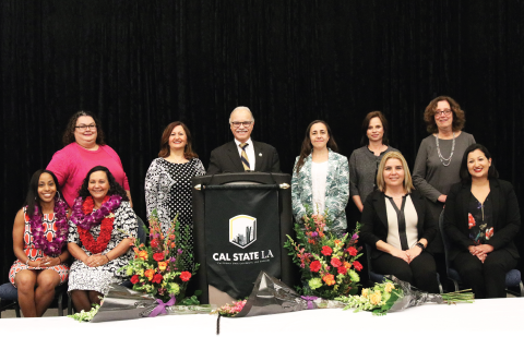 President Covino with a group of distinguished women honorees.