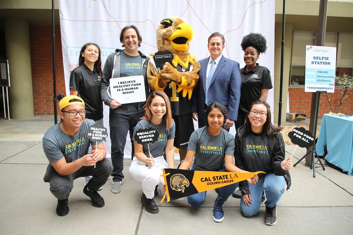 Everytable student employees pose for a group photo with CEO Sam Polk and Cal State LA VP Jose A. Gomez