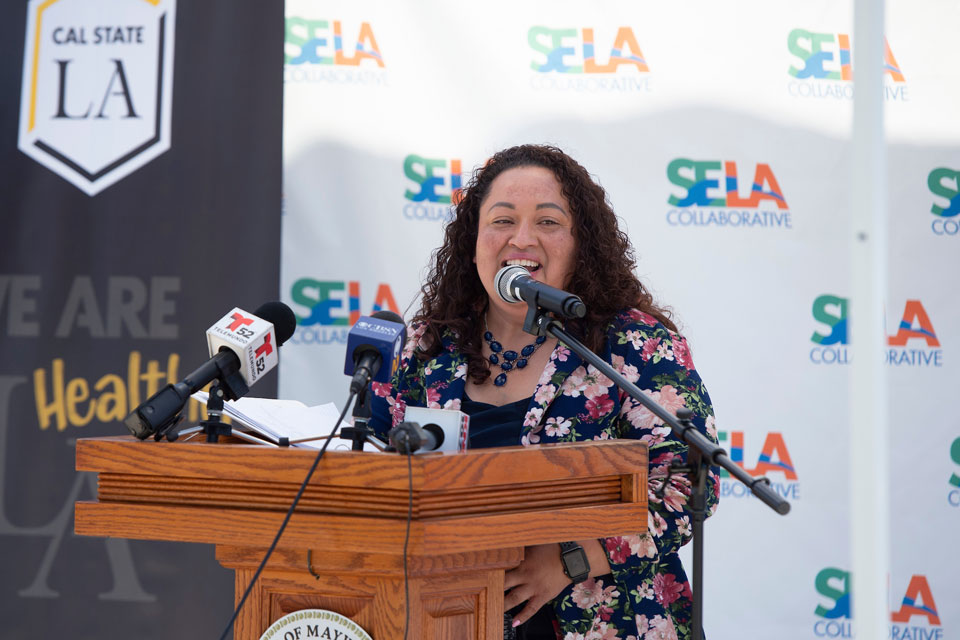 Wilma Franco, executive director for the SELA Collaborative, delivers remarks during the news conference