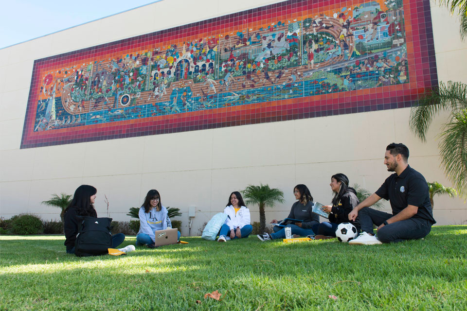 Cal State LA students hanging out on campus nearby the university's Physical Education building.
