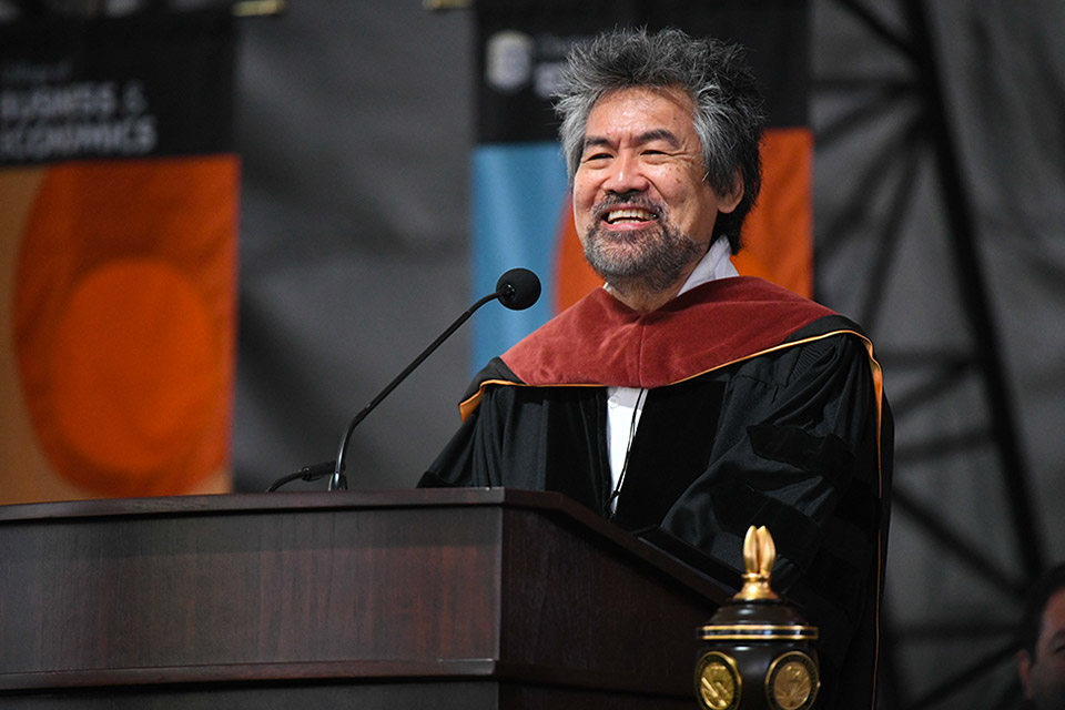 David Henry Hwang speaks into a microphone at the lectern.