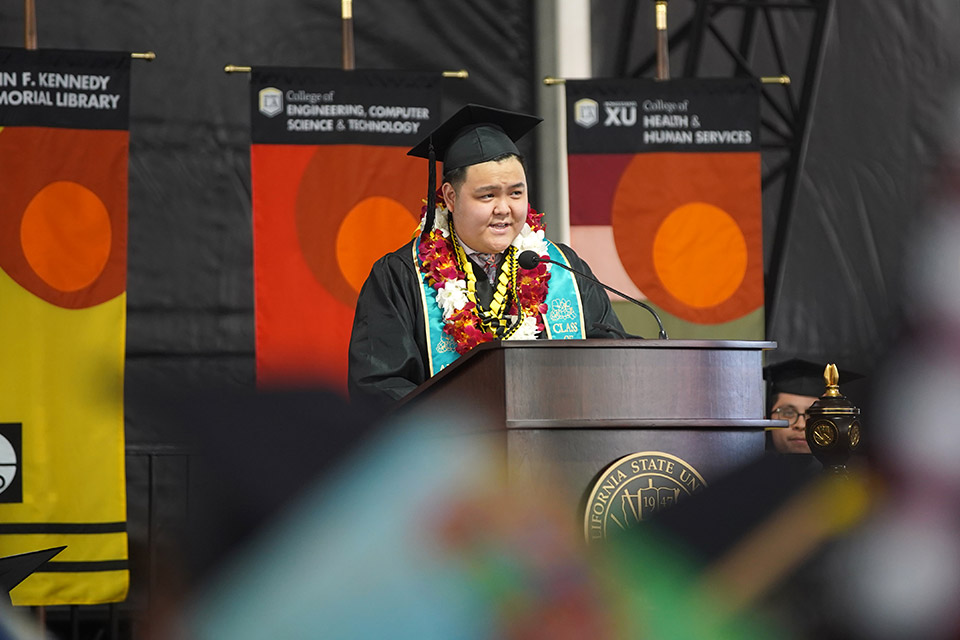 Richard Hu in Commencement regalia delivers remarks at lectern