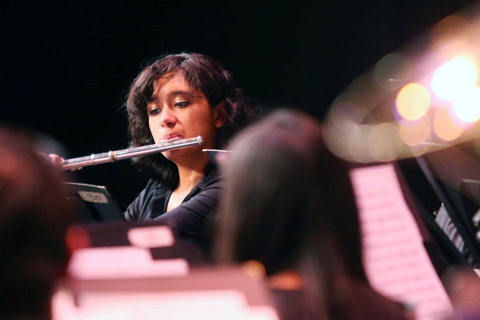 A Cal State LA student playing the flute.