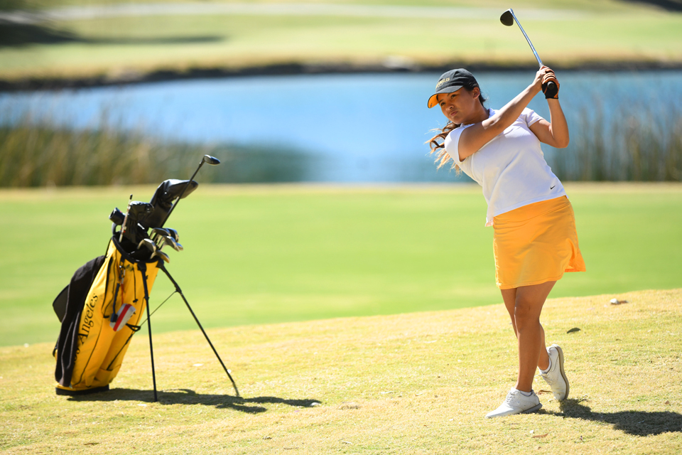 Cal State LA athlele, Pratima Sherpa, swing a golf club.