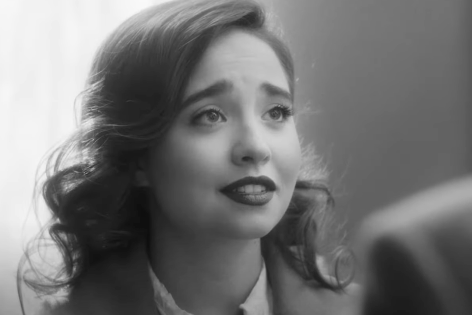 An actress in a black and white scene from a short film.