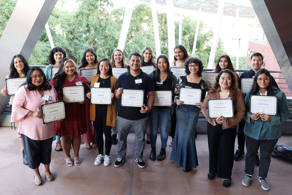 A group of students pose with their scholarship certificates.