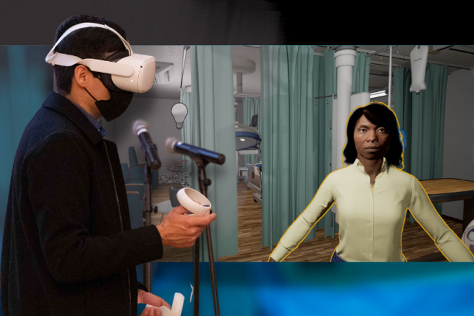 A student wearing a VR headset stands next to a VR patient.