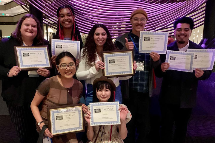 Students pose for a photo with the award certificates.