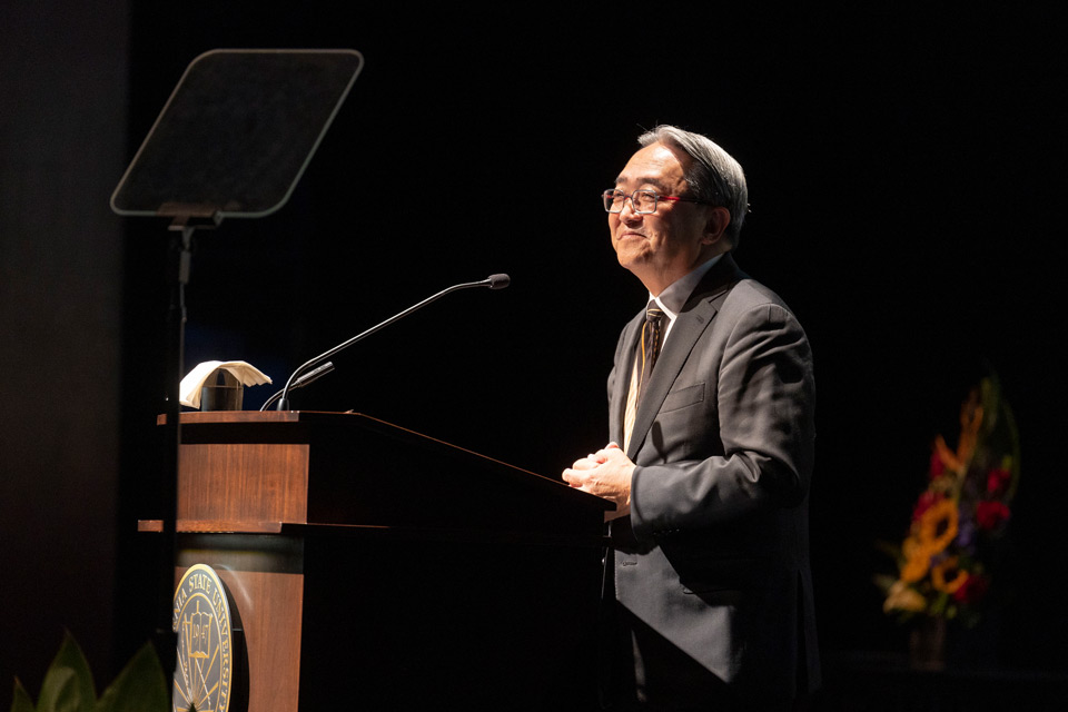 President Morishita speaks from behind a podium.