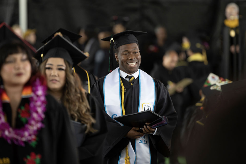 A graduate walks during a commencement ceremony.