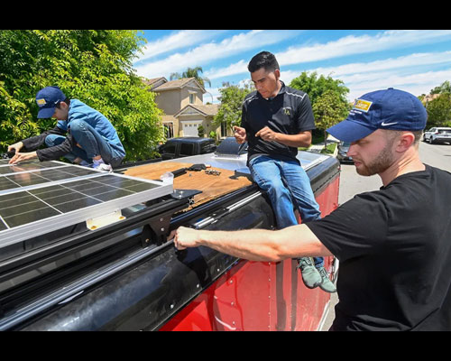 People working on assembling solar panels.