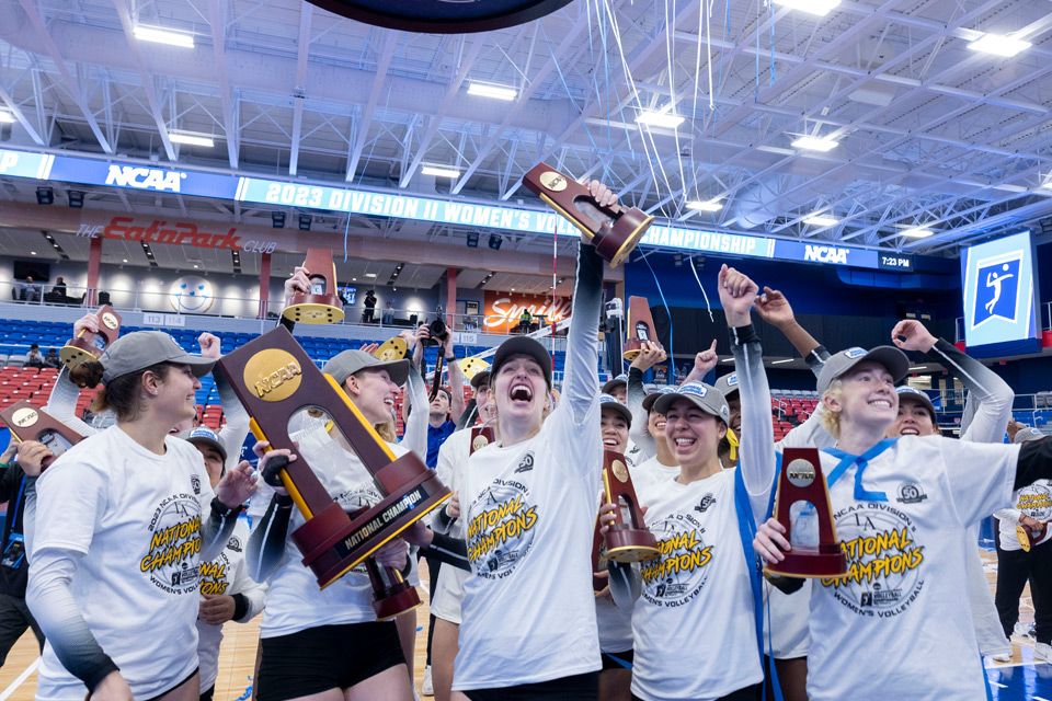 Women's Volleyball team celebrating their championship victory.