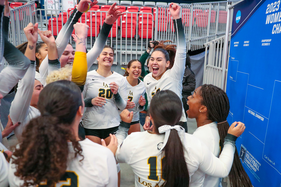 Women's Volleyball team celebrating their victory.