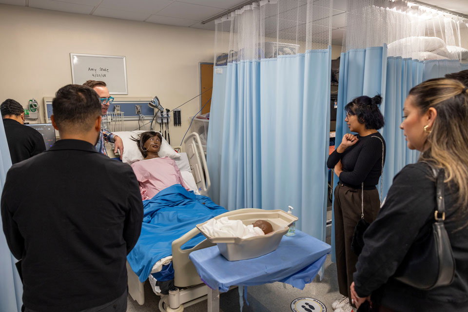 Nursing students give a demonstration to visitors.