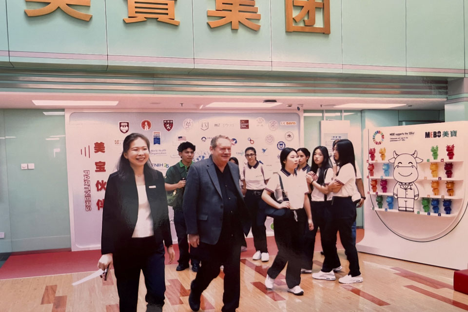 A Cal State LA professor walks through a shop in China.