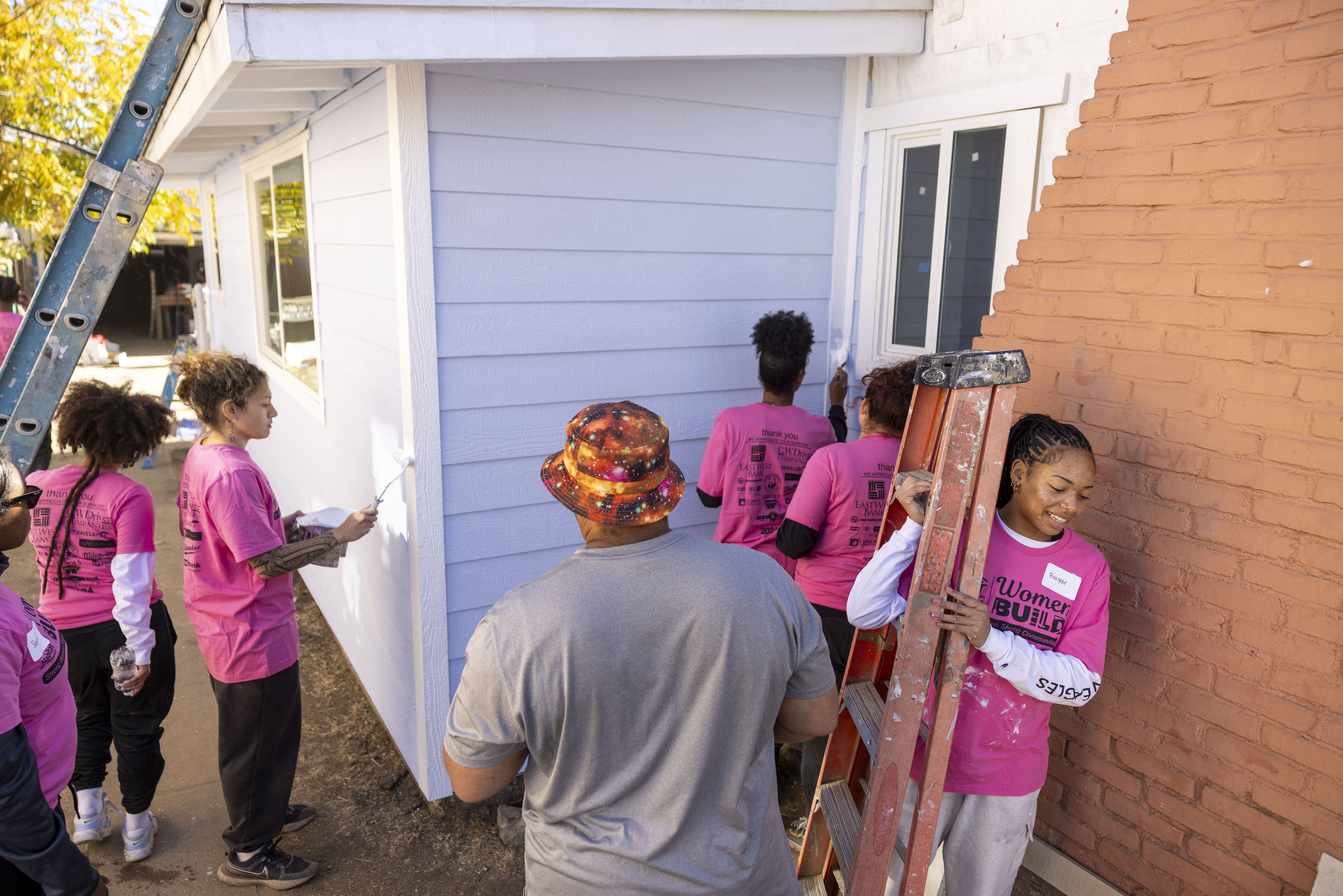 Members of the Cal State LA women’s basketball team help with the refurbishing of a Habit for Humanity home in El Sereno.