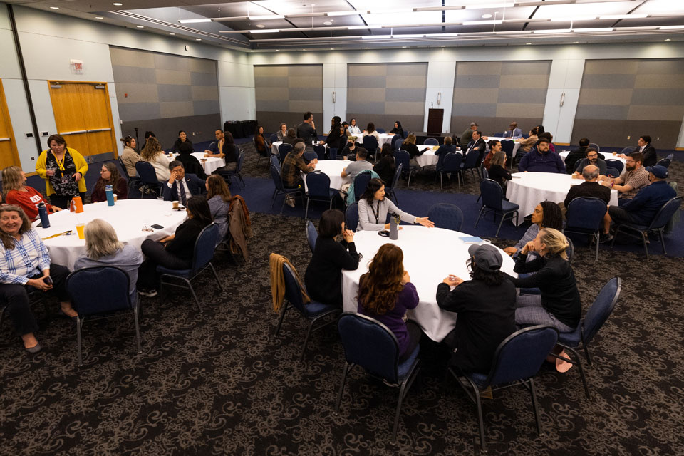 Campus community sits together at several tables to participate in the healing circles.