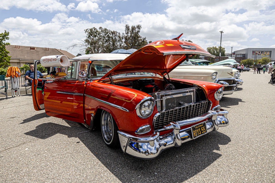 Classic red car with its hood open on display at an outdoor car show event at Cal State LA.