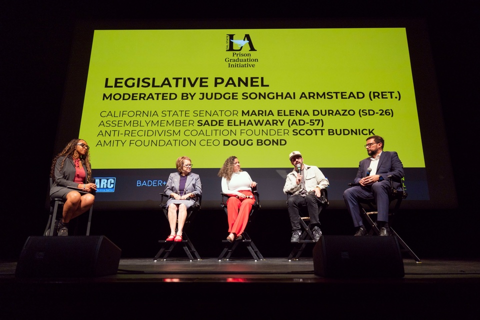 Panelists sit on stage beneath a large “Legislative Panel” presentation screen during a Prison Graduation Initiative event at Cal State LA. 