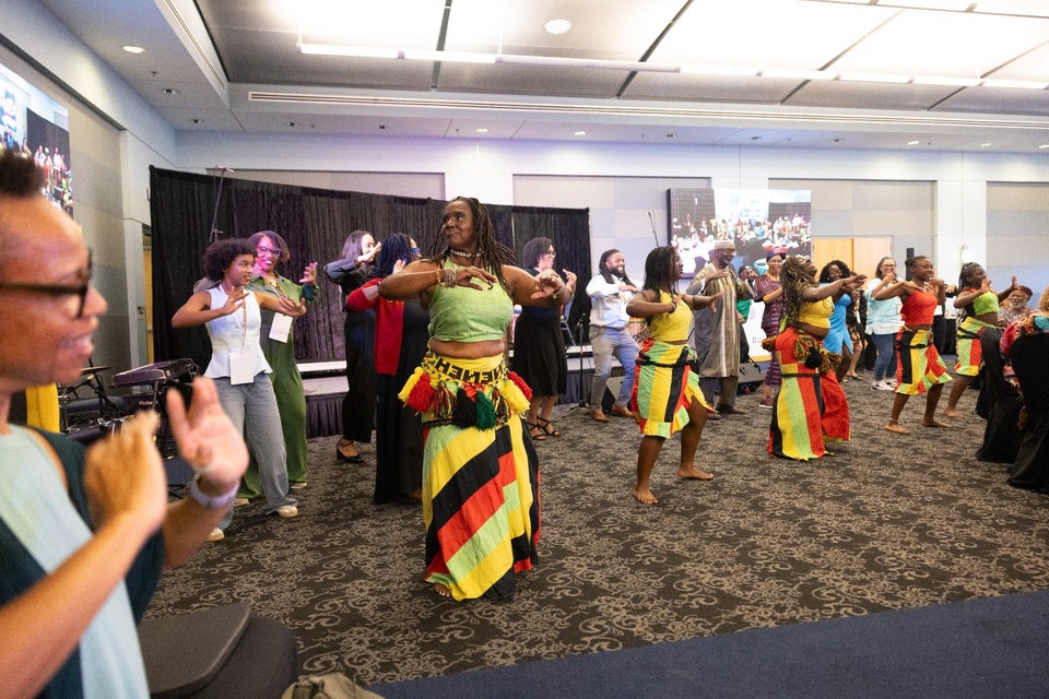 Performers and attendees participate in a cultural dance during the Juneteenth Symposium at Cal State LA.