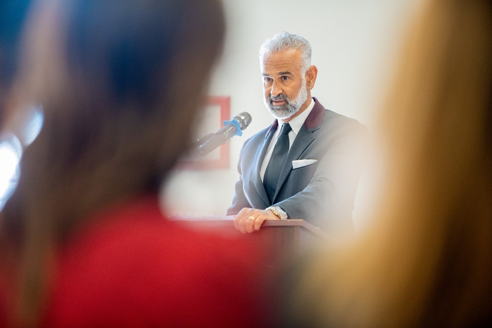 Speaker delivers remarks at a podium during a Prison Graduation Initiative ceremony at Cal State LA, viewed through the audience. 