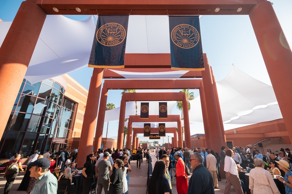 Cal State LA community members gather outdoors beneath University banners during Convocation 2026.